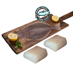 wild-Halibut-whole-fish-fillets-lime-on-brown-wood-plate-miami-fresh-fish-market