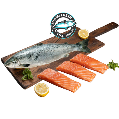 wild-King-salmon-whole-fish-with-salmon-slices-lime-on-brown-wood-plate