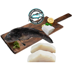 Whole-sea-bass-Fish-with-slices-of-fillets-on-brown-wood-plate-miami-fresh-fish-market